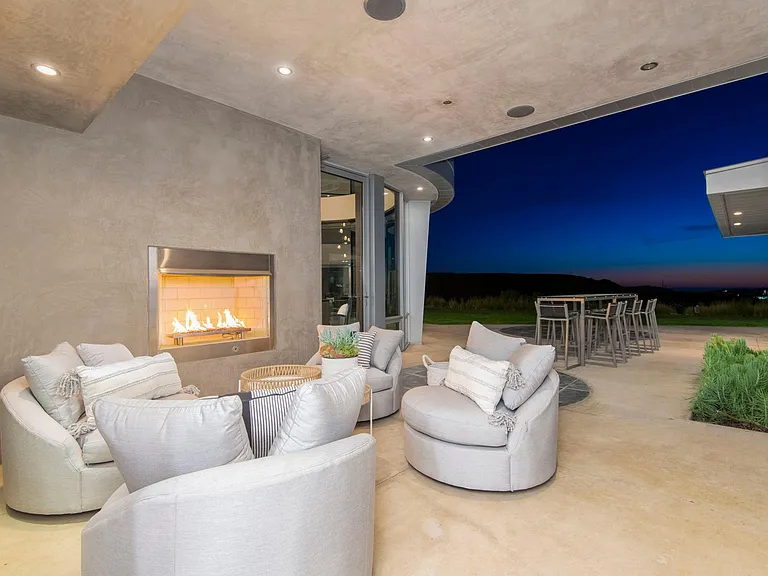 San Diego Family Estate — covered patio and fireplace at dusk