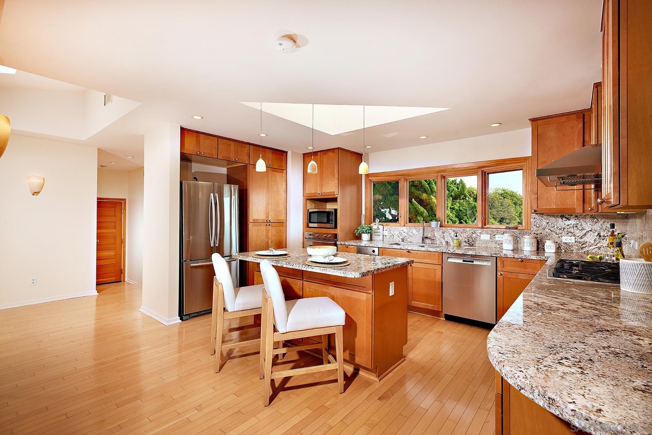 La Jolla Reimagined — renovated kitchen with island seating and skylight