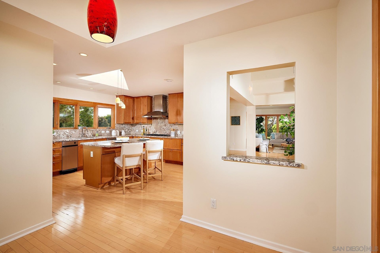 La Jolla Reimagined — kitchen pass-through connecting to living spaces