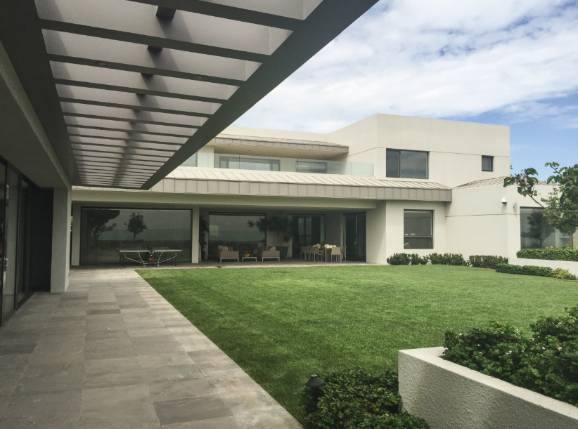 Baja Estate — rear courtyard with pergola and lawn
